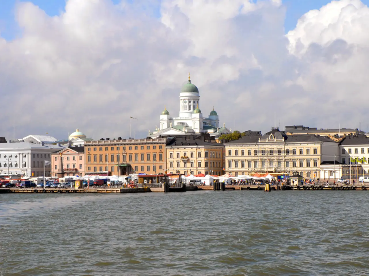 In this picture there is a brown and white color building with many windows. Behind there is a...