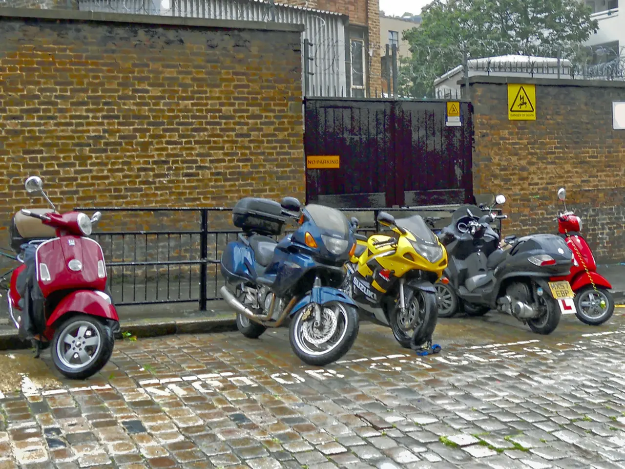 In this image there are vehicles parked on the road. Behind them there is a railing on the walkway....