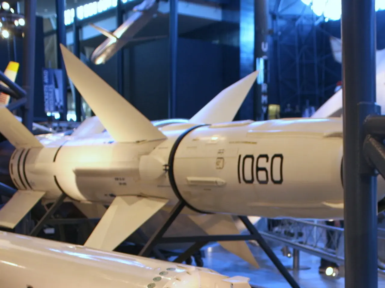 In this image there is a rocket, in the background there are iron poles.