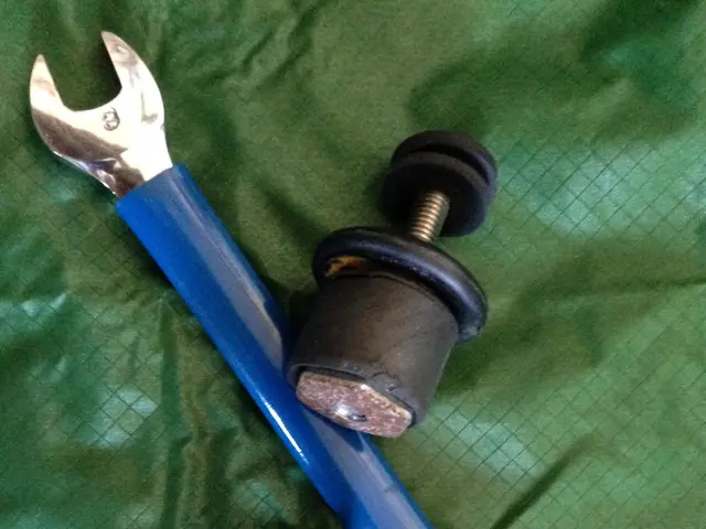 In this image we can see a wrench and some objects placed on the surface.