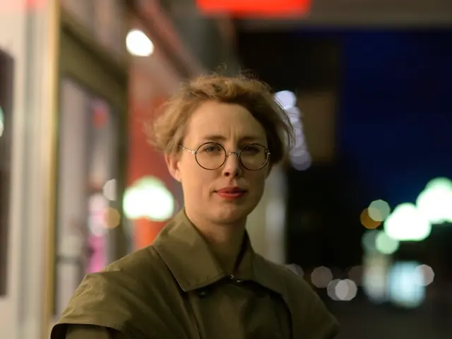 In this picture there is a woman wearing spectacles and there is a store in the left corner and...