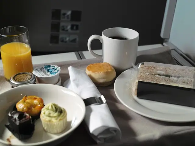 In this picture we can see plates,food items,cup,glass and cloth.