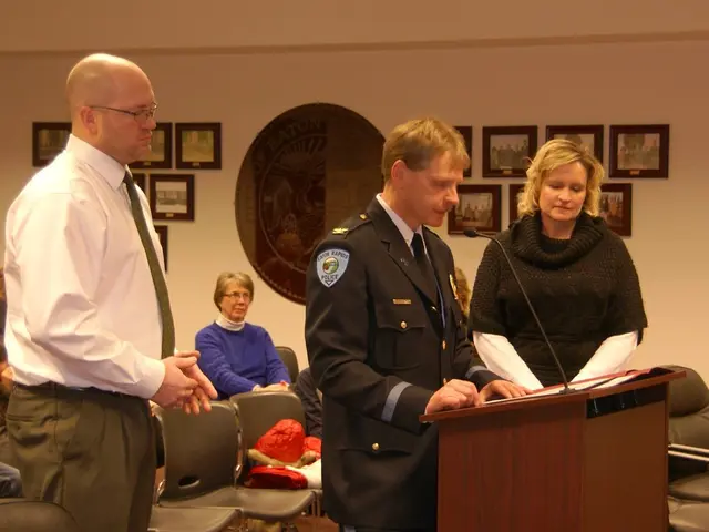 In this picture, we see two men and a woman are standing. The man in the middle of the picture is...