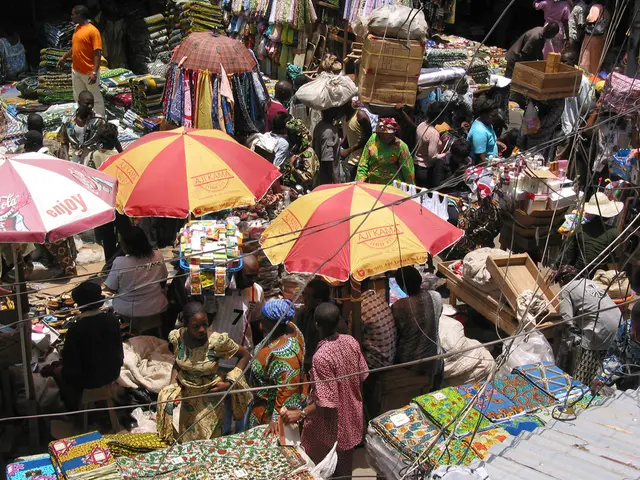 In this picture we can see a market, in which we can see some stoles and we can see few people are...